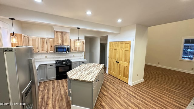 kitchen featuring appliances with stainless steel finishes, gray cabinetry, tasteful backsplash, hanging light fixtures, and a kitchen island