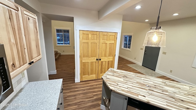 kitchen featuring decorative light fixtures, light brown cabinets, and dark hardwood / wood-style floors