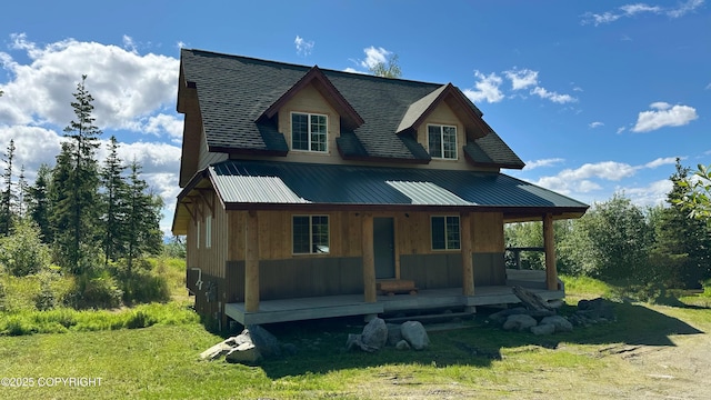 9742 W Trimotor St, Wasilla, AK 99623 - view of front of property featuring a porch, metal roof, and roof with shingles