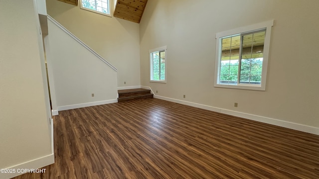 9742 W Trimotor St, Wasilla, AK 99623 - unfurnished living room with dark wood-type flooring, baseboards, and high vaulted ceiling