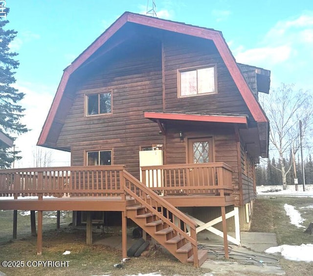 back of property featuring a wooden deck