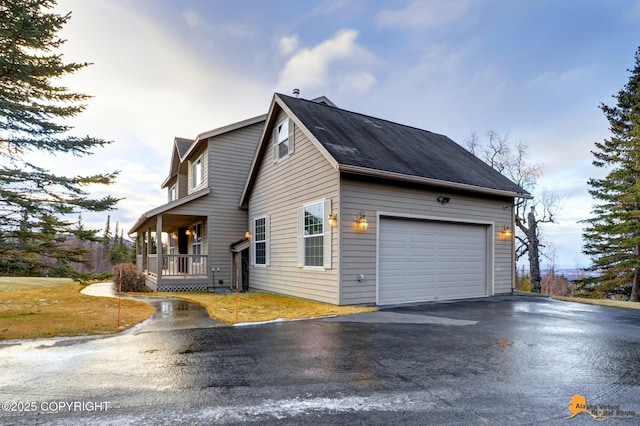 view of property exterior featuring a porch and a garage