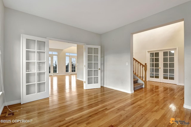 spare room featuring light hardwood / wood-style flooring and french doors