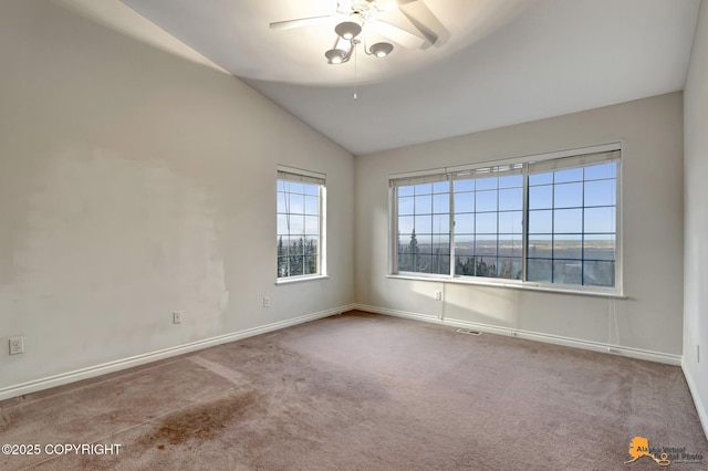 spare room with vaulted ceiling, ceiling fan, and light carpet