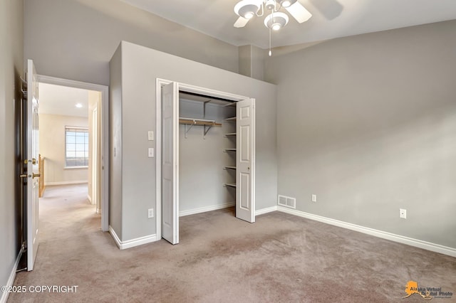 unfurnished bedroom with a closet, ceiling fan, and light carpet