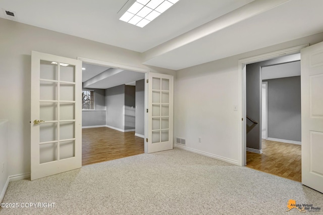 carpeted empty room with french doors