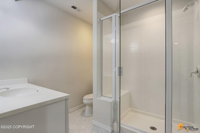 bathroom with vanity, toilet, and an enclosed shower