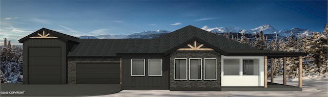 view of front of home with a mountain view and a garage