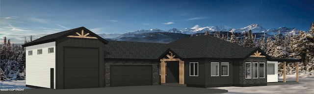 view of front of house featuring a garage and a mountain view