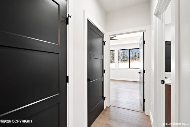 corridor with light hardwood / wood-style flooring