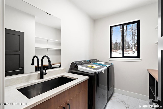 washroom featuring washer and clothes dryer and sink