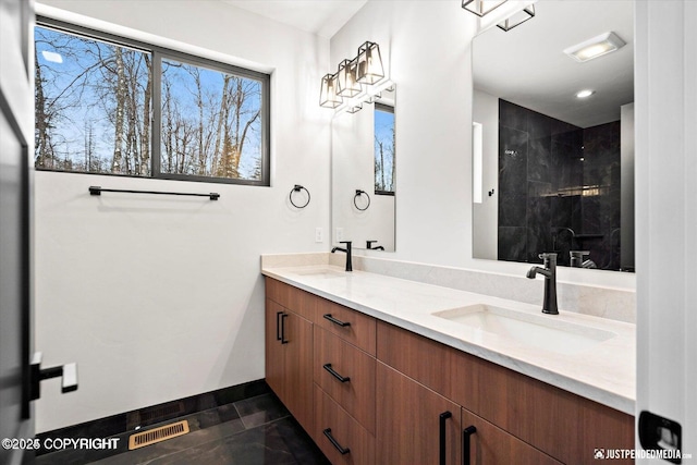 bathroom with walk in shower, vanity, and tile patterned floors