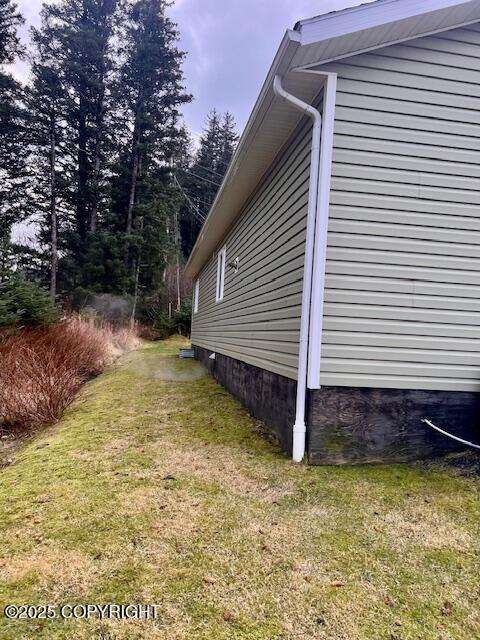 view of side of home featuring a lawn