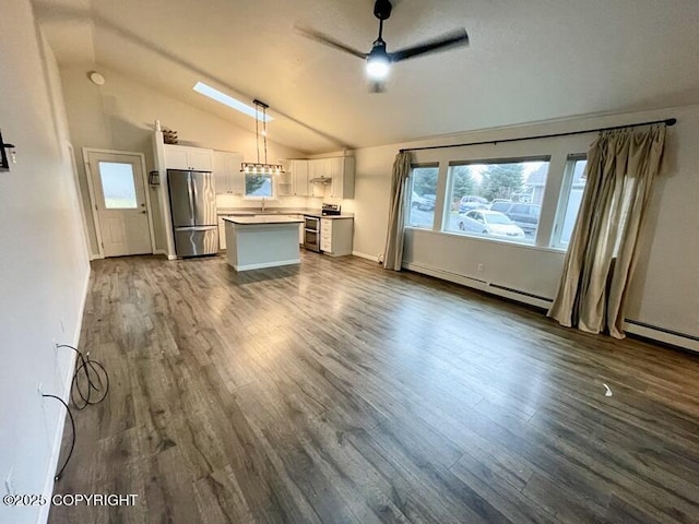 unfurnished living room featuring vaulted ceiling, dark hardwood / wood-style floors, and ceiling fan