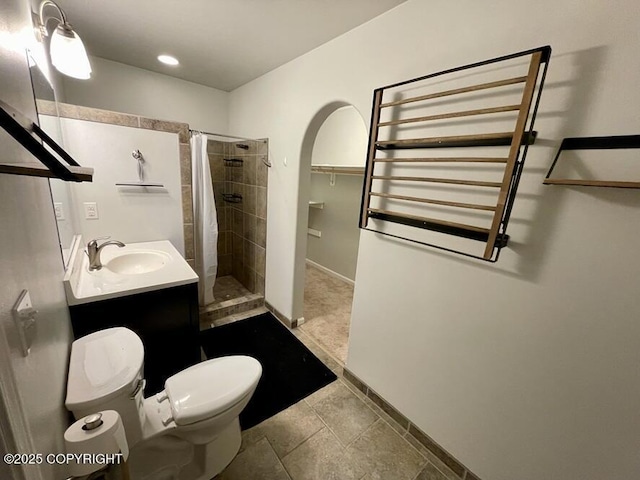 bathroom with vanity, a shower with curtain, tile patterned floors, and toilet