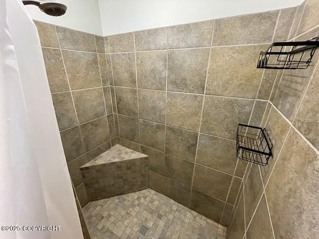 bathroom with tiled shower