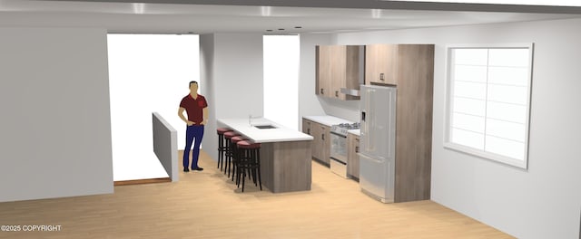 kitchen featuring sink, light wood-type flooring, stainless steel stove, white refrigerator with ice dispenser, and a center island