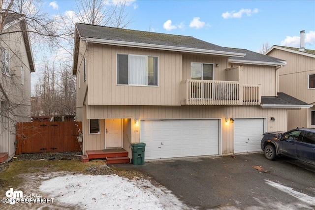 view of property with a garage and a balcony