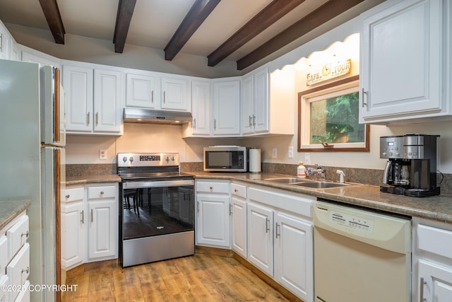 kitchen with appliances with stainless steel finishes, light hardwood / wood-style flooring, and white cabinetry