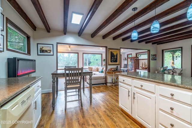 kitchen featuring white cabinets, white dishwasher, decorative light fixtures, and beamed ceiling