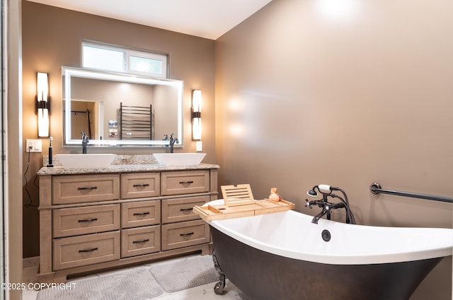 bathroom featuring vanity and a washtub