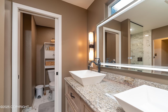 bathroom featuring walk in shower, vanity, and toilet