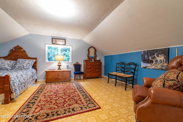 bedroom with a textured ceiling and vaulted ceiling