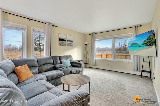 living room featuring plenty of natural light, a baseboard radiator, and carpet floors