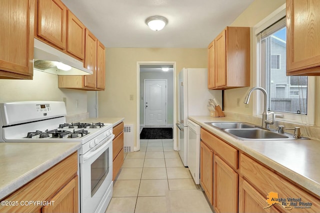 kitchen featuring white appliances, light tile patterned floors, a sink, light countertops, and under cabinet range hood