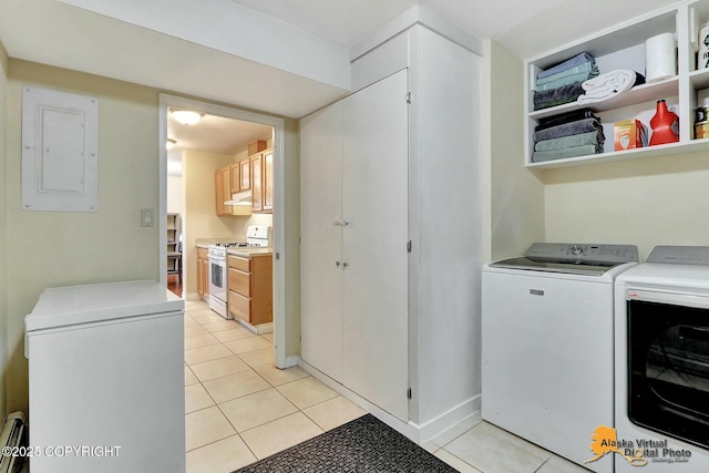 clothes washing area with independent washer and dryer, electric panel, a baseboard heating unit, light tile patterned floors, and laundry area