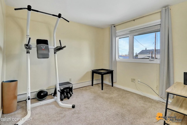 workout room featuring baseboard heating and carpet flooring