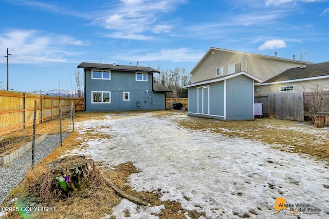 rear view of property featuring a fenced backyard