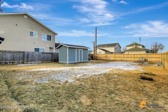 view of yard featuring a fenced backyard, a storage shed, and an outdoor structure