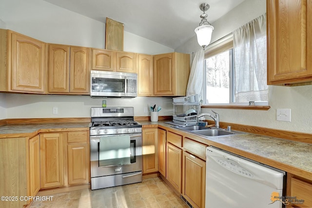 kitchen featuring sink, vaulted ceiling, hanging light fixtures, and appliances with stainless steel finishes