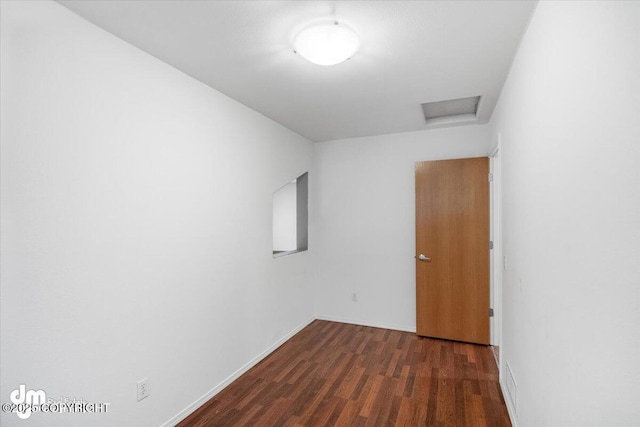 unfurnished room featuring dark wood-type flooring