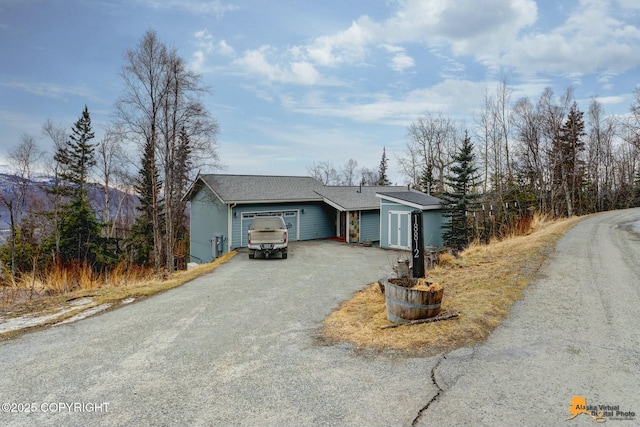 single story home featuring aphalt driveway