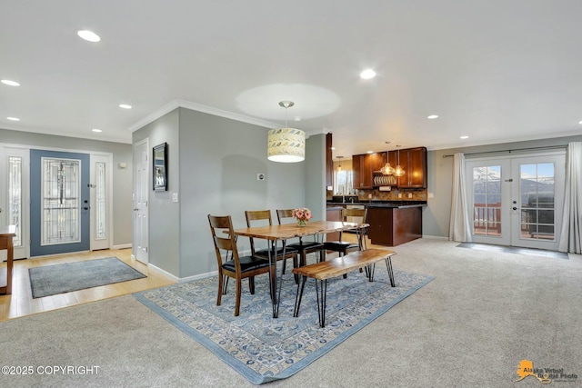 dining area with ornamental molding, a healthy amount of sunlight, and baseboards