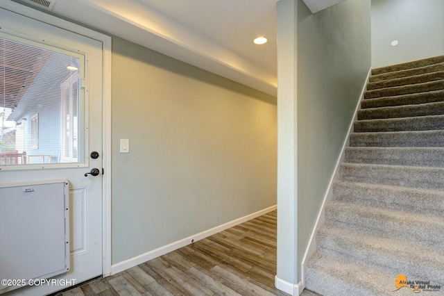 interior space featuring recessed lighting, baseboards, and wood finished floors