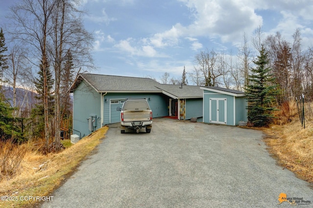 view of front of house featuring aphalt driveway and an attached garage