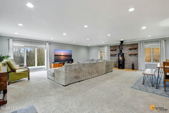 living area with carpet, a wood stove, crown molding, and recessed lighting