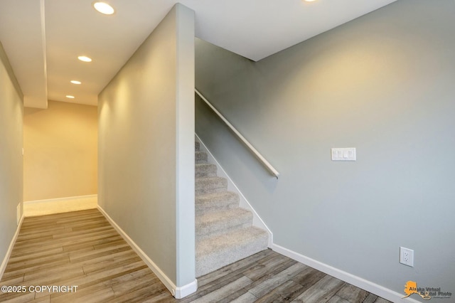 stairs featuring recessed lighting, baseboards, and wood finished floors