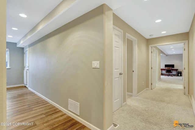 corridor featuring baseboards, visible vents, wood finished floors, and recessed lighting