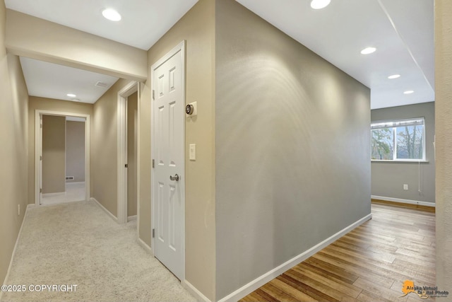 corridor featuring recessed lighting, wood finished floors, and baseboards