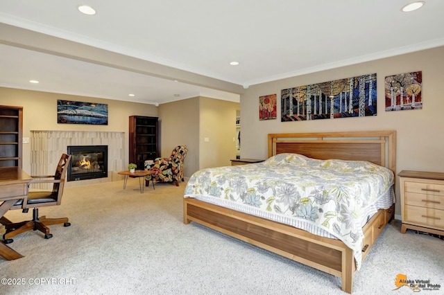 bedroom featuring a glass covered fireplace, crown molding, carpet, and recessed lighting