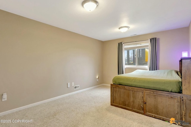 carpeted bedroom with visible vents and baseboards