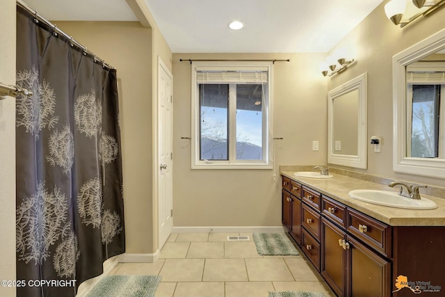 full bathroom featuring double vanity, tile patterned flooring, a sink, and visible vents