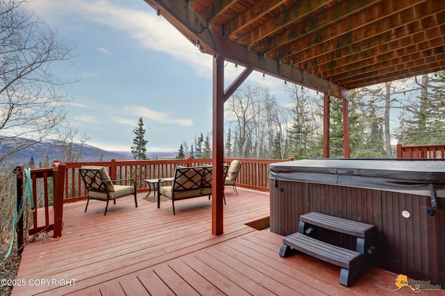 deck featuring a mountain view and a hot tub