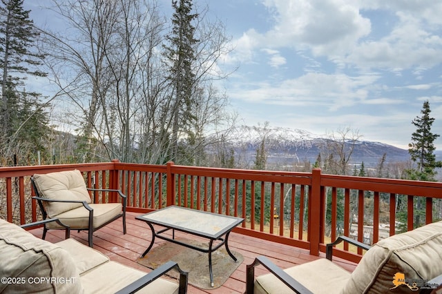 wooden terrace featuring outdoor lounge area and a mountain view