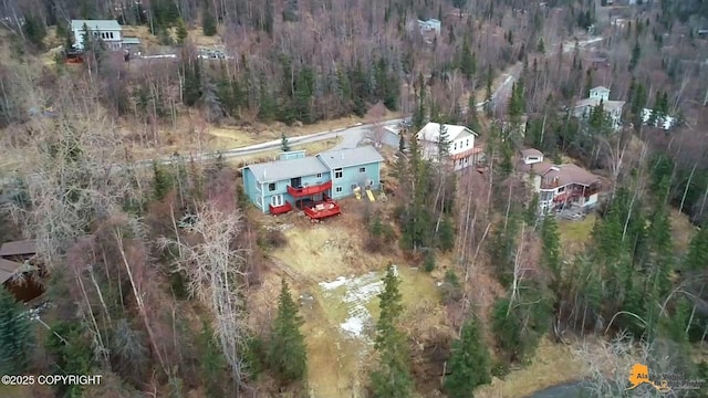 drone / aerial view featuring a wooded view