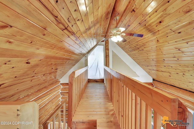 corridor featuring wood ceiling, light wood-type flooring, log walls, and vaulted ceiling